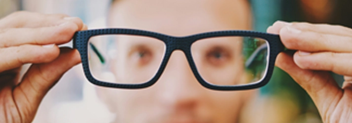 Eye Doctor Cape Girardeau MO Glasses 2 A person holding black glasses.